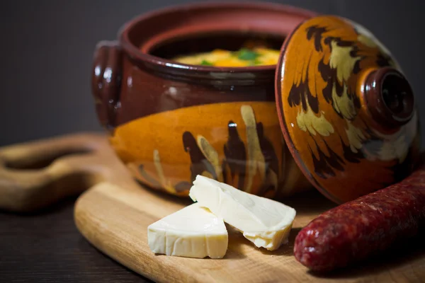 Stew pot with sausage and cheese — Stock Photo, Image