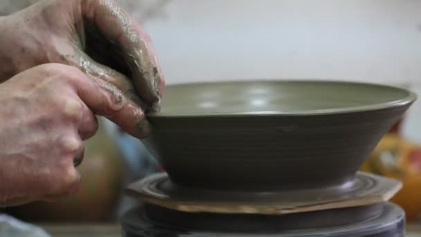 Handwerker stellt Teller auf Töpferscheibe her — Stockvideo