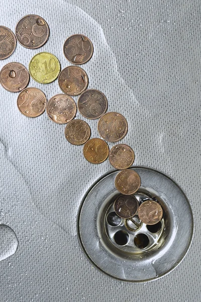 Coins go to drain — Stock Photo, Image