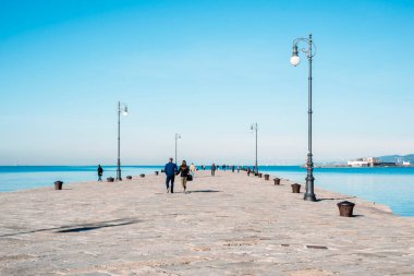 many people walking at famous Audace Pier in Trieste city, Italy
