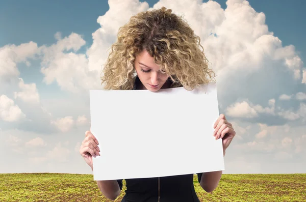 Business woman with blank poster — Stock Photo, Image