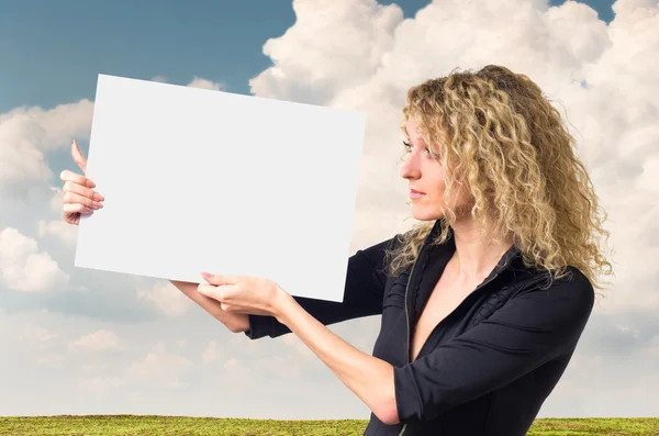 Business woman with blank poster — Stock Photo, Image