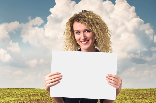 Business woman with blank poster — Stock Photo, Image