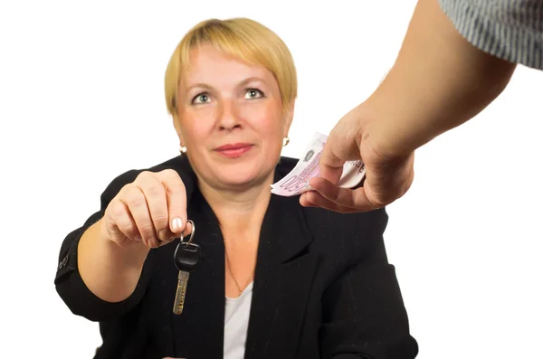 Mature businesswoman gives the keys for the money — Stock Photo, Image