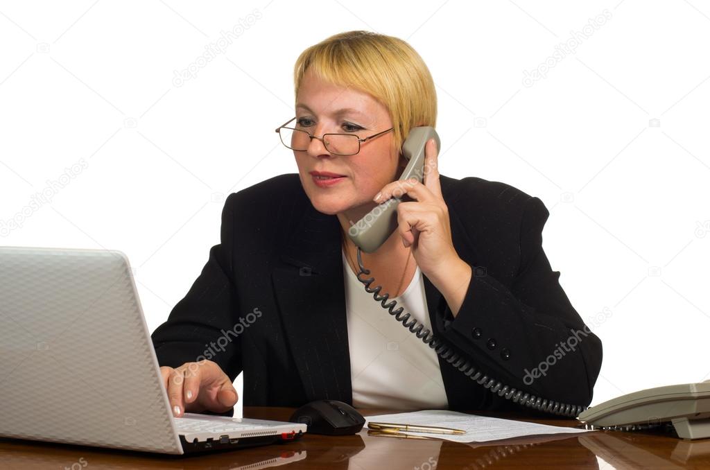 Mature businesswoman calling on the phone and check something on