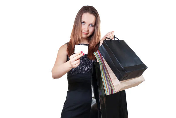 Beautiful woman with shopping bag showing a credit card — Stock Photo, Image