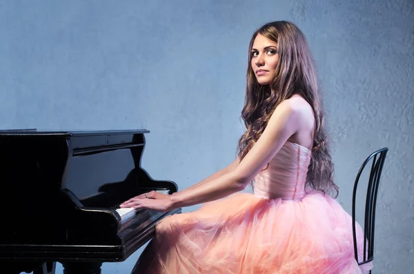 Portrait of woman with grand piano Royalty Free Stock Images