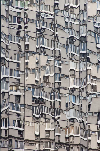 Block of flats reflected in the mirror windows — Stock Photo, Image