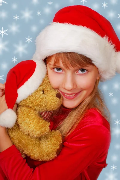 Christmas girl with teddy bear Stock Image