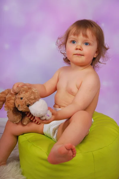 Little baby girl playing with mascots — Stock Photo, Image