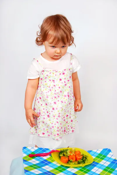 Little baby girl looking on broccoli and carrot — Stock Photo, Image