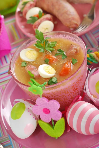 Easter white borscht with quail eggs and sausage in pink glass — Stock Photo, Image