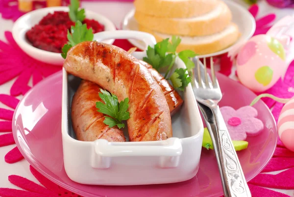 Grilled white sausage with beetroot sauce for easter — Stock Photo, Image