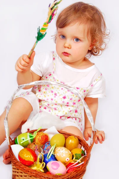 Baby girl and easter basket with eggs — Stock Photo, Image