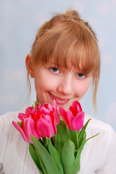 Beautiful girl with bouquet of tulips — Stock Photo, Image