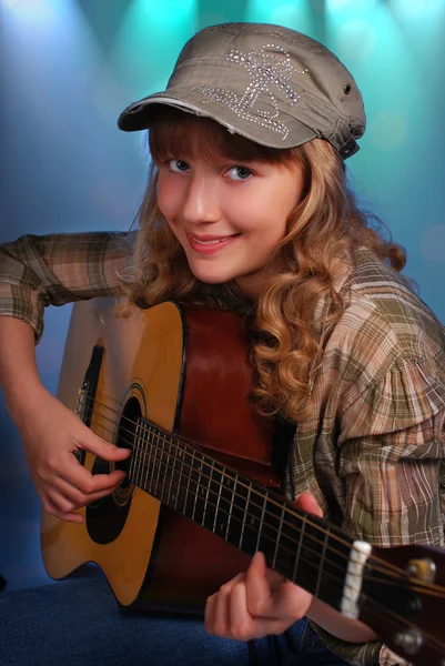 Young girl playing guitar on the stage — Stock Photo, Image