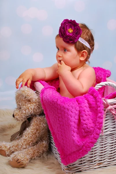 Beautiful baby girl in wicker basket ,10 months — Stock Photo, Image