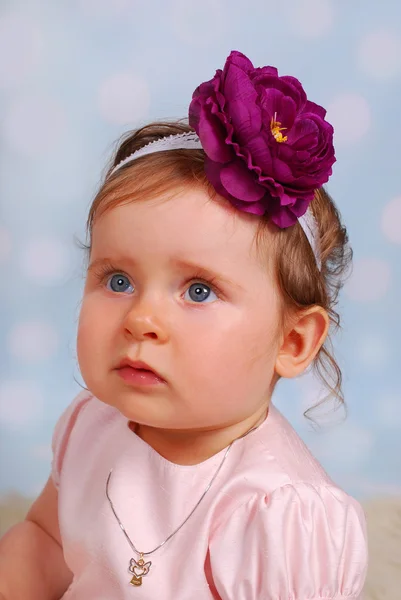 Lovely little baby girl with flower — Stock Photo, Image