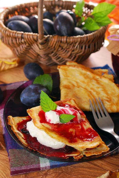 Pancakes with plum confiture and whipped cream — Stock Photo, Image