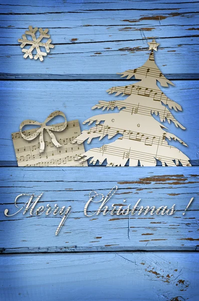Boże Narodzenie symbol kształty wycięte z muzyka, nuty na niebieski bac drewniane — Zdjęcie stockowe