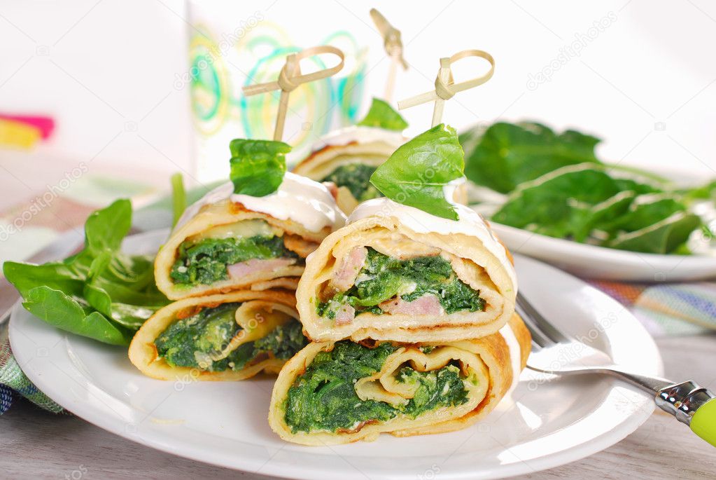 rolled spinach pancakes as shashlik on sticks