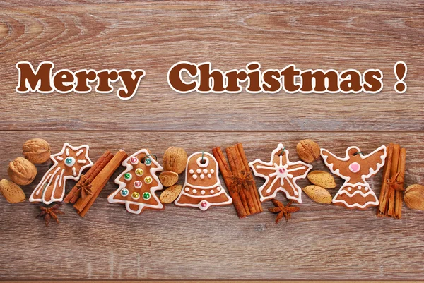 Christmas border with gingerbread cookies and spices on wooden b — Stock Photo, Image
