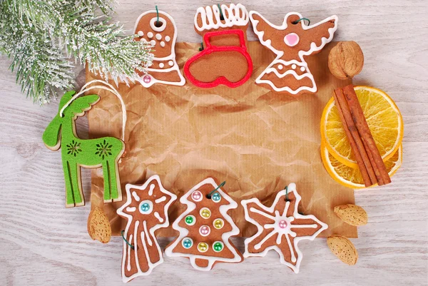 Christmas frame with gingerbread cookies and spices on old pape — Stock Photo, Image