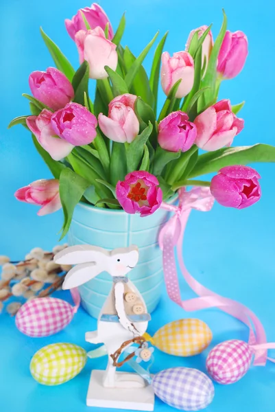 Easter decoration with wooden bunny and fresh tulips Royalty Free Stock Photos