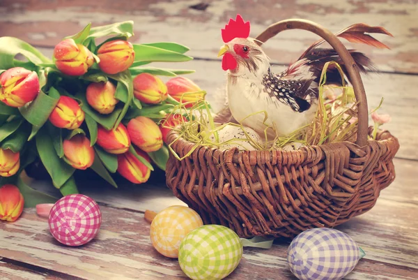 Wicker basket with rooster and eggs for easter — Stock Photo, Image