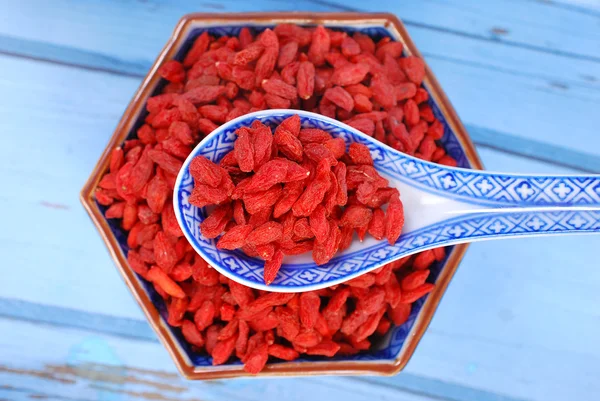 Dried goji berries on chinese spoon and in a bowl — Stock Photo, Image