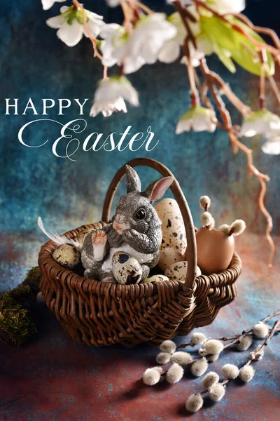 复活节卡片 上面挂着柳条筐 里面装满了鸡蛋 背景上坐着兔子的雕像 — 图库照片