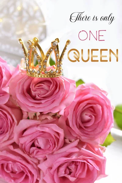 Diamond crown on bunch of pink roses with inscription There is only one queen