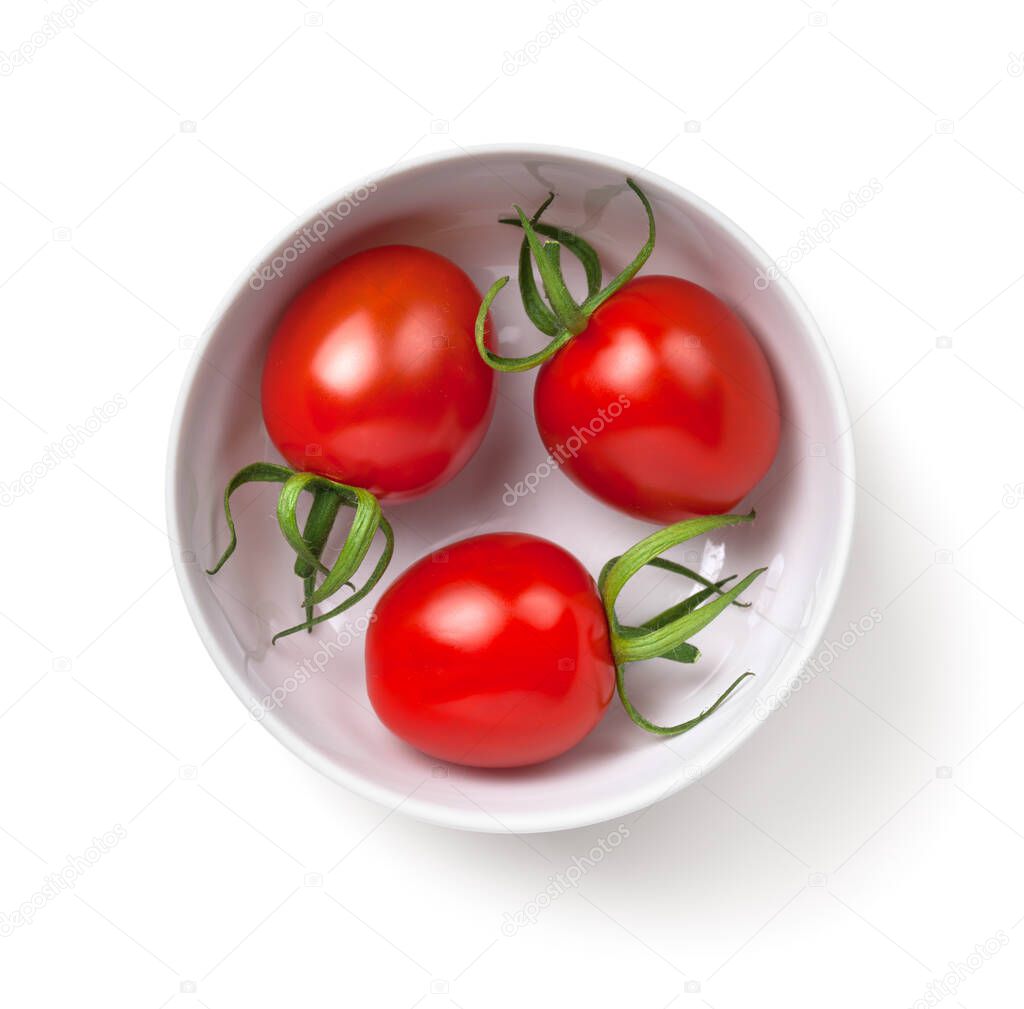 Three cherry tomatoes in white bowl isolated over white background. Top view