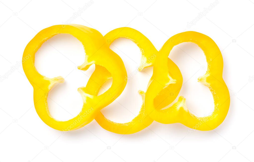 Yellow bell pepper slices isolated over white background. View from above