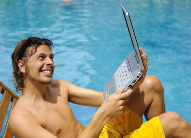 havuz kenarında güneşlenirken genç adam