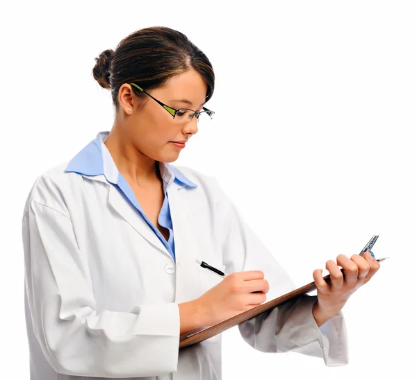 Medical doctor writing on clipboard — Stock Photo, Image