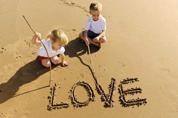 Kids writing in sand — Stock Photo, Image