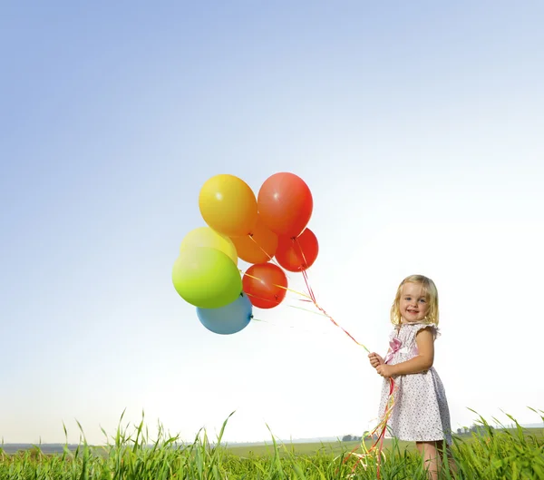 Μικρό κορίτσι παίζει με μπαλόνια — Φωτογραφία Αρχείου