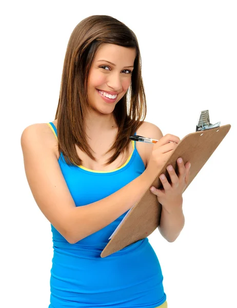 Молодая женщина, пишущая на планшете Стоковое Изображение