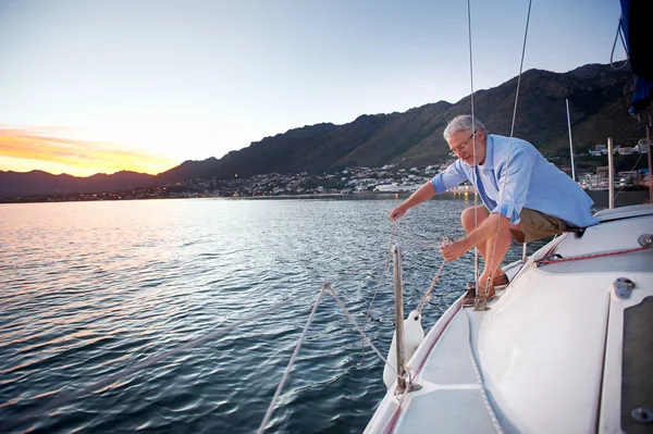 Sailing mature man — стоковое фото