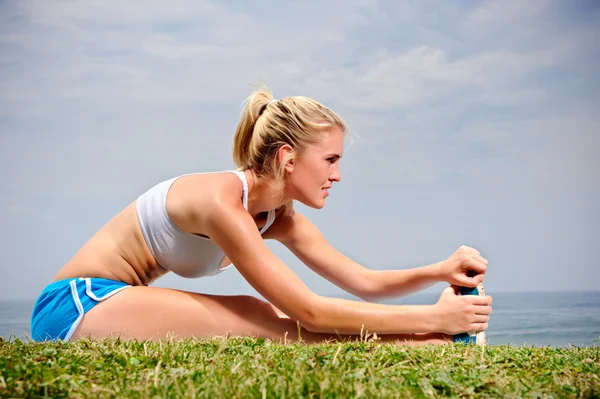 Blond girl stretches — Stock Photo, Image