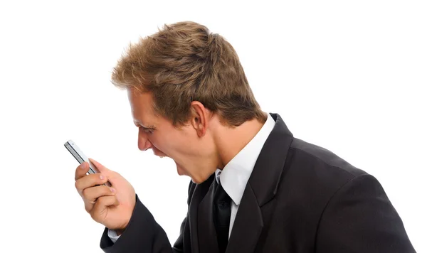 Young man holding his cellphone against a white background — Stock Photo, Image