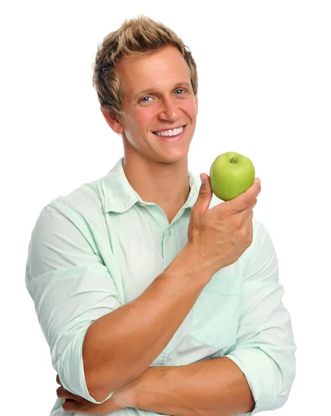 Schöner junger Mann mit einem Apfel in der Hand — Stockfoto