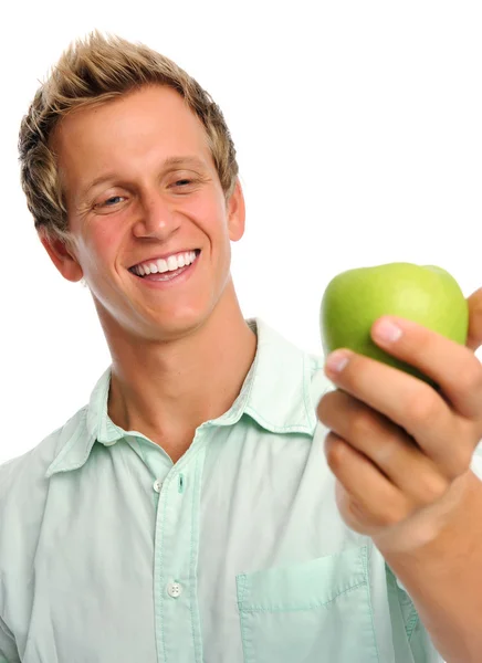 Handsome young man holding an apple Royalty Free Stock Images