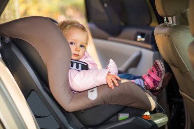 Infant baby girl in car seat clipart