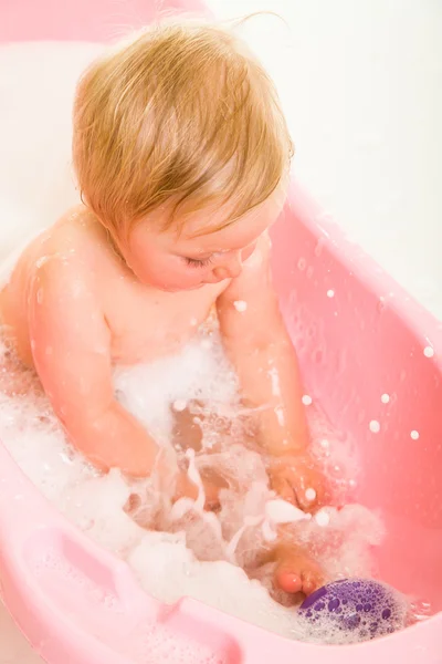 Cute infant girl in bath isolated on white — Stock Photo, Image
