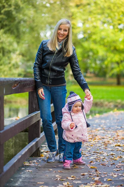 Kojenecká holčička v golden podzimní park — Stock fotografie