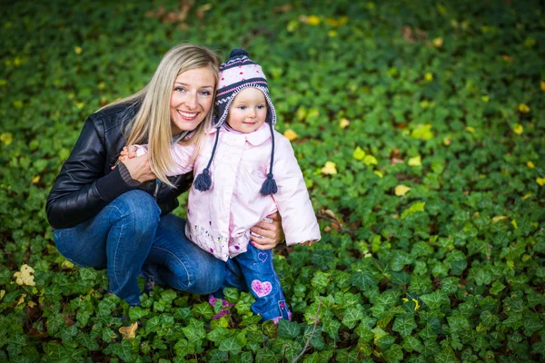 Infant baby girl in golden autumn park — Stock Photo, Image