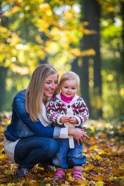 Infant baby girl in golden autumn park — Stock Photo, Image