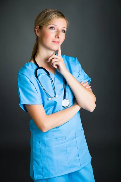 Mulher em médico uniforme segurando prancheta — Fotografia de Stock